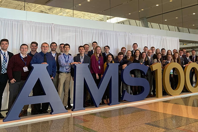 PSUBAMS members in front of AMS 100th sign at annual meeting