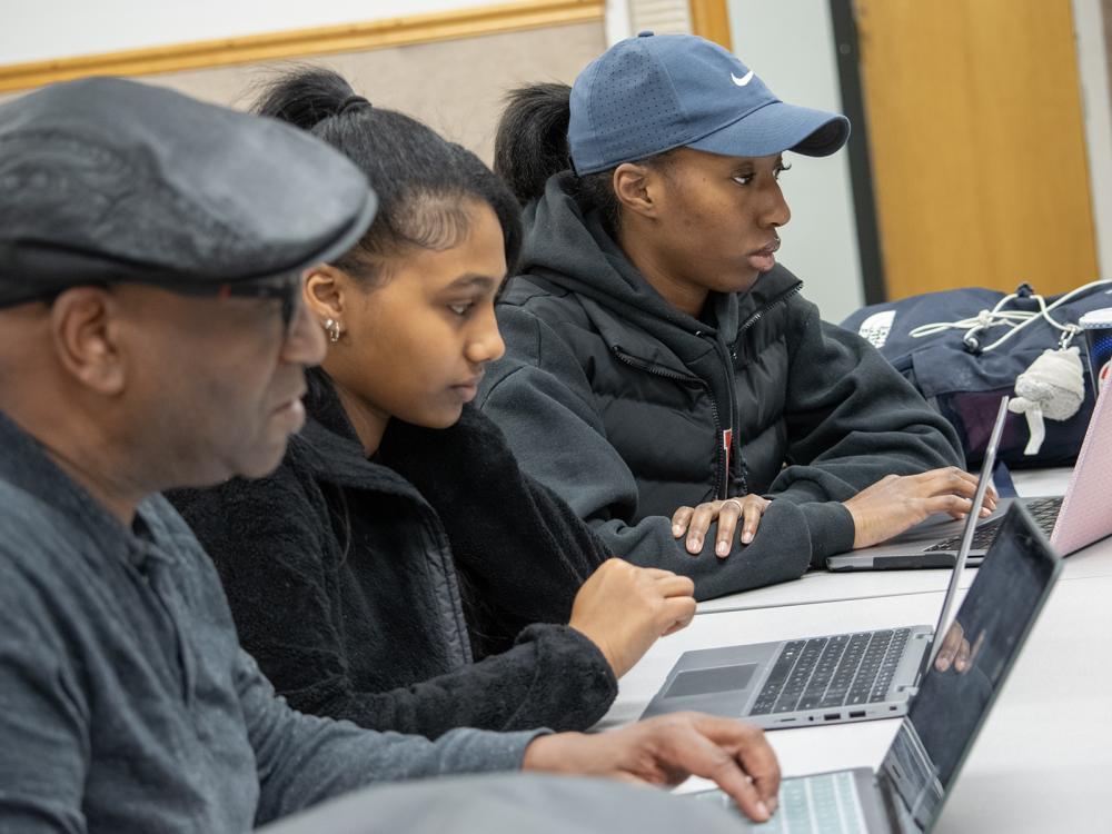 Greg Jenkins, professor of meteorology and atmospheric science at Penn State, high school student Ariam Gebrezgi, and Penn State Harrisburg student Makaylin Valley go over research during an EnvironMentors meeting.