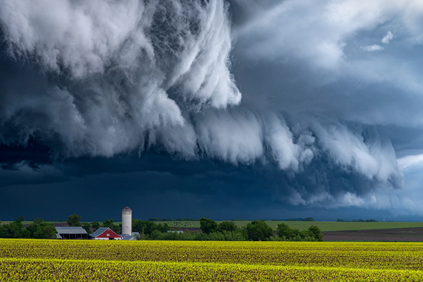 Thunder clouds build over a farm in the Midwestern United States.
